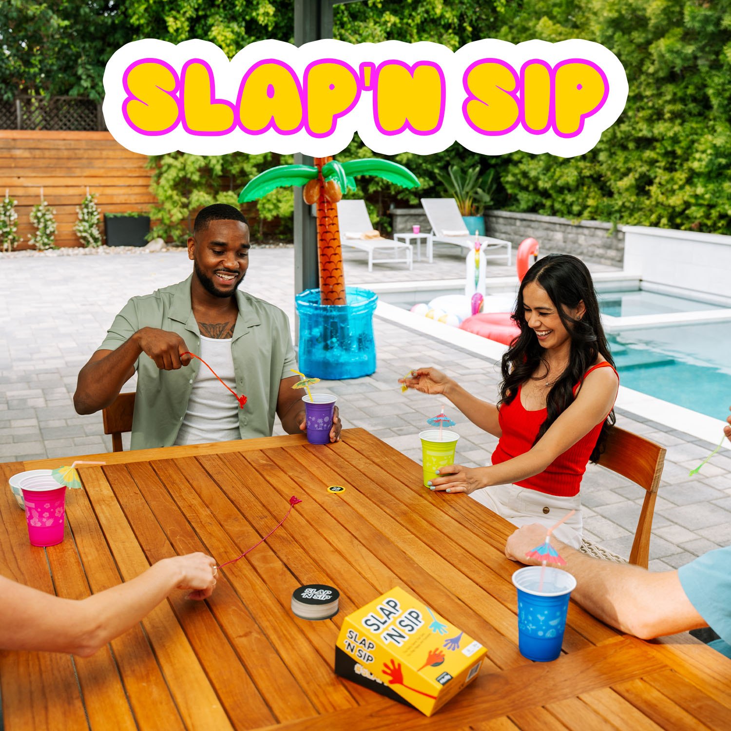 Friends playing Slap ’N Sip at a poolside table
